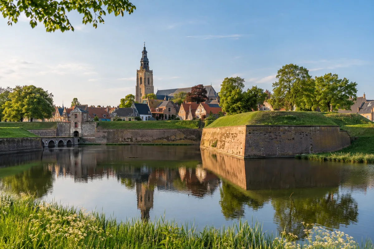 Historische vestingstad in Noord-Brabant met een stadsmuur en water in de gracht